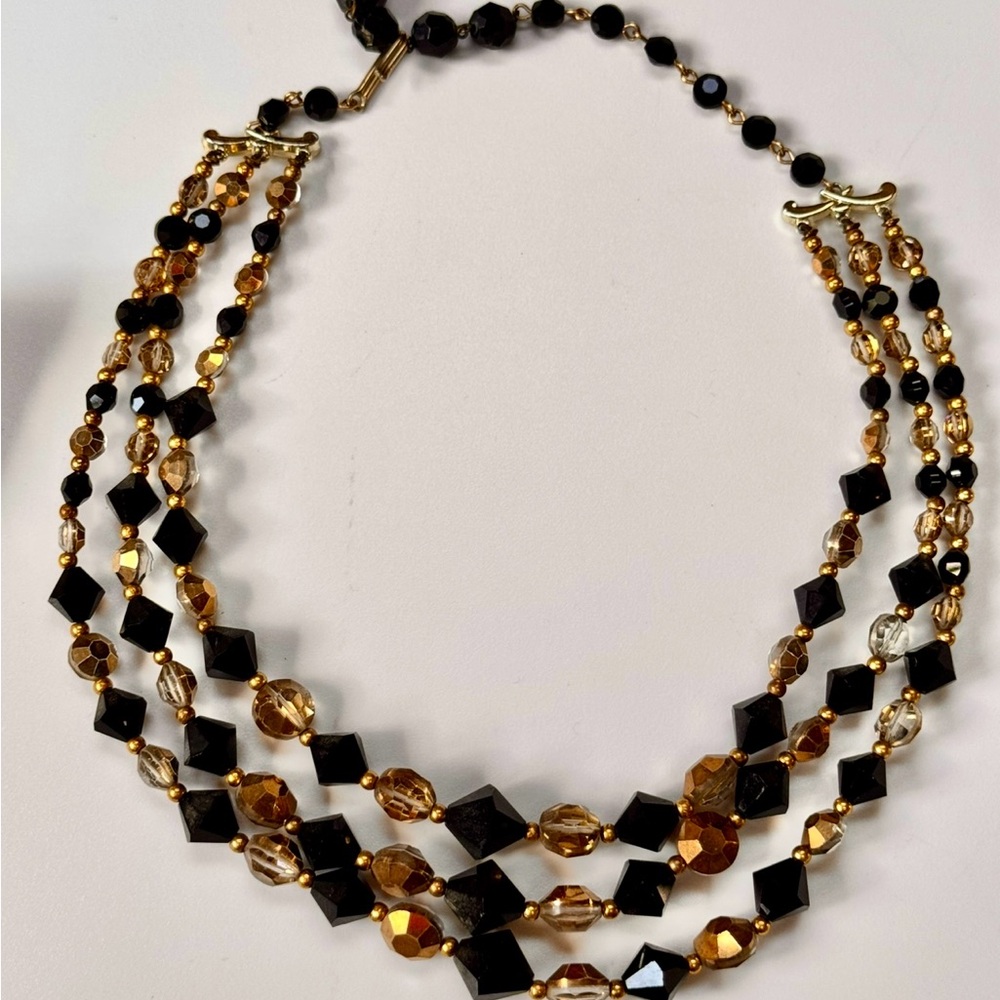 Vintage triple-strand black and amber glass beaded necklace with gold-tone